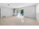 Open living space features tile flooring and sliding glass doors to the backyard at 9014 Great Sound Dr, Orlando, FL 32827