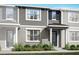 Charming townhome featuring a stylish facade, well-maintained landscaping, and inviting front entryway at 9976 Red Canoe Aly, Orlando, FL 32832