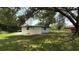 A large, well-maintained lawn surrounds a newly painted white house on a sunny day at 1011 W 16Th St, Sanford, FL 32771