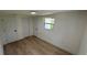 Cozy bedroom with hardwood floors, white walls and natural lighting at 1011 W 16Th St, Sanford, FL 32771