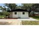 Charming, freshly painted white home with a black roof, tidy front yard, and a paved driveway at 1011 W 16Th St, Sanford, FL 32771