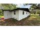 Rear exterior view of a white house featuring new windows and roof at 1011 W 16Th St, Sanford, FL 32771