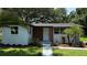 Exterior view of home with well-manicured lawn and tropical landscaping at 1011 W 16Th St, Sanford, FL 32771