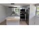 Modern kitchen with stainless steel appliances, stone countertops, and a center island at 1011 W 16Th St, Sanford, FL 32771