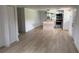Open-concept living room leading into modern kitchen with stainless steel appliances and hardwood floors at 1011 W 16Th St, Sanford, FL 32771