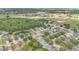 Aerial shot of a suburban neighborhood, featuring residential streets, homes, and green spaces at 10984 Pinewood Cove Ln, Orlando, FL 32817