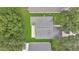 Aerial view of a home with a gray roof surrounded by lush greenery at 10984 Pinewood Cove Ln, Orlando, FL 32817