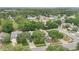 Aerial view showcasing the neighborhood homes surrounded by mature trees and landscaping at 10984 Pinewood Cove Ln, Orlando, FL 32817