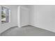 Comfortable bedroom with neutral carpeting, closet, and a window overlooking the neighborhood at 10984 Pinewood Cove Ln, Orlando, FL 32817