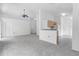 Open-concept living room with a breakfast bar, new carpeting, and easy access to the kitchen at 10984 Pinewood Cove Ln, Orlando, FL 32817