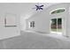Bright living room with vaulted ceiling, large windows, and sliding door to the backyard at 10984 Pinewood Cove Ln, Orlando, FL 32817