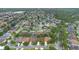 A wide aerial view of a neighborhood with well-maintained homes, mature trees, and community pond at 1107 Carringdale Dr, Orlando, FL 32828