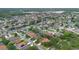 A wide aerial view of a neighborhood with well-maintained homes, mature trees, and community ponds at 1107 Carringdale Dr, Orlando, FL 32828