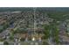 An aerial view of a single-Gathering home in a quiet neighborhood, with mature trees and well-maintained landscaping at 1107 Carringdale Dr, Orlando, FL 32828