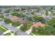 An aerial view of a single-Gathering home with a well-maintained lawn and mature trees in a quiet neighborhood at 1107 Carringdale Dr, Orlando, FL 32828
