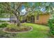 Lush backyard with enclosed patio, mature tree, and manicured lawn at 1107 Carringdale Dr, Orlando, FL 32828