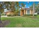 A beautifully landscaped front yard complements this single-story home with lush green grass at 1107 Carringdale Dr, Orlando, FL 32828