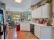 Well-lit kitchen with white cabinets, wood floors, and modern appliances creating a functional space at 1107 Carringdale Dr, Orlando, FL 32828
