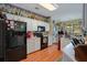 Modern kitchen featuring black appliances, white cabinets, and wood floors, offering ample space at 1107 Carringdale Dr, Orlando, FL 32828