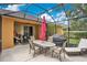 Enclosed patio features outdoor dining, grill, and lounge furniture at 1107 Carringdale Dr, Orlando, FL 32828