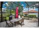 Enclosed patio features outdoor dining, grill, and lounge furniture at 1107 Carringdale Dr, Orlando, FL 32828