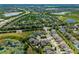 Expansive aerial view of a neighborhood with lush trees, serene lakes, and convenient highway access at 12530 Climbing Vine Ct, Windermere, FL 34786
