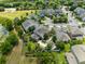 Aerial view of luxury home showcasing lush landscaping, custom water feature and outdoor entertaining space at 12530 Climbing Vine Ct, Windermere, FL 34786