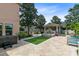 Outdoor oasis featuring travertine tile, custom water feature, outdoor kitchen and covered seating area at 12530 Climbing Vine Ct, Windermere, FL 34786