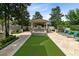 Resort style backyard complete with travertine tile, custom water feature, manicured landscaping and covered area for outdoor dining at 12530 Climbing Vine Ct, Windermere, FL 34786