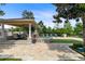 Outdoor oasis showcasing travertine tile, custom water feature, lounge chairs and covered outdoor kitchen and dining area at 12530 Climbing Vine Ct, Windermere, FL 34786