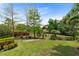 Lush green backyard complete with manicured landscaping, mature trees and private fence at 12530 Climbing Vine Ct, Windermere, FL 34786