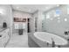 Elegant bathroom features a soaking tub, glass enclosed shower, and double vanity at 12530 Climbing Vine Ct, Windermere, FL 34786