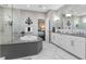 Bright bathroom boasts a soaking tub, glass enclosed shower, and double sinks at 12530 Climbing Vine Ct, Windermere, FL 34786