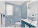 Charming powder room with eye-catching wallpaper and vanity at 12530 Climbing Vine Ct, Windermere, FL 34786
