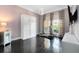 Bright bedroom with a Murphy bed, dark hardwood floors, and large windows at 12530 Climbing Vine Ct, Windermere, FL 34786