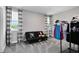 Cozy bedroom with futon, curtains, and clothes rack at 12530 Climbing Vine Ct, Windermere, FL 34786