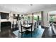 Stylish dining area featuring an open design to kitchen and sliding glass doors to lanai at 12530 Climbing Vine Ct, Windermere, FL 34786
