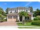 Beautiful two-story home boasting a manicured lawn, three-car garage, and appealing architectural elements at 12530 Climbing Vine Ct, Windermere, FL 34786