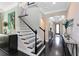 Elegant foyer showcasing dark wood floors, an ornate staircase, and sophisticated decor at 12530 Climbing Vine Ct, Windermere, FL 34786