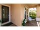 Welcoming front porch featuring a decorative door, arched windows, and a cozy bench with pillows at 12530 Climbing Vine Ct, Windermere, FL 34786