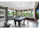 Entertaining game room boasting a pool table, custom cabinets, and large windows with natural light at 12530 Climbing Vine Ct, Windermere, FL 34786