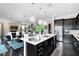 Open concept kitchen with a large island, stainless steel appliances, and adjacent dining area at 12530 Climbing Vine Ct, Windermere, FL 34786