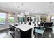 Well-appointed kitchen with dark cabinets, quartz counters, a center island, and an open floor plan at 12530 Climbing Vine Ct, Windermere, FL 34786