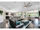 Open-concept living room with modern furnishings, hardwood floors, and a seamless connection to the dining area at 12530 Climbing Vine Ct, Windermere, FL 34786