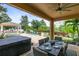 Covered patio offers outdoor dining, a hot tub, and a view of the backyard at 12530 Climbing Vine Ct, Windermere, FL 34786