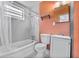 Bathroom showcasing a tub-shower combination with tiled walls, along with essential fixtures at 1330 Lakeview Rd, Lake Wales, FL 33853