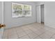 Clean, airy bedroom with a window, tiled floor, and closet, offering ample storage and natural light at 1330 Lakeview Rd, Lake Wales, FL 33853
