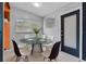 Bright dining area featuring a glass table, modern chairs, and a view of the yard through the window at 1330 Lakeview Rd, Lake Wales, FL 33853