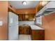 Functional kitchen features wooden cabinets, white appliances, and a clean layout, perfect for cooking at 1330 Lakeview Rd, Lake Wales, FL 33853