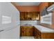 Functional kitchen features wooden cabinets, white appliances, and a clean layout, perfect for cooking at 1330 Lakeview Rd, Lake Wales, FL 33853